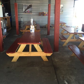 Swamp Daddy Crawfish - empty picnic tables in a garage - Seafood Near Me - Baytown, Texas