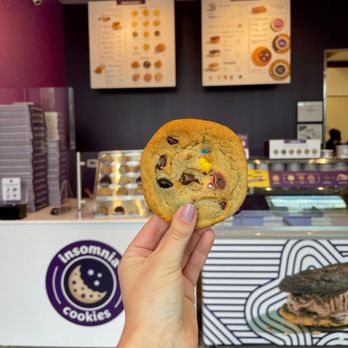 Insomnia Cookies - a hand holding a chocolate chip cookie - Ice Cream & Frozen Yogurt Near Me - Fayetteville, Arkansas Insomnia Cookies - a hand holding a chocolate chip cookie - Ice Cream & Frozen Yogurt Near Me - Fayetteville, Arkansas