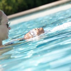 Sunsational Swim School - Private Swim Lessons - Sunsational Instructor teaching a student how to float on her back