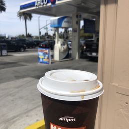 Medium covfefe in front of gas pumps. Nothing happy about brew.