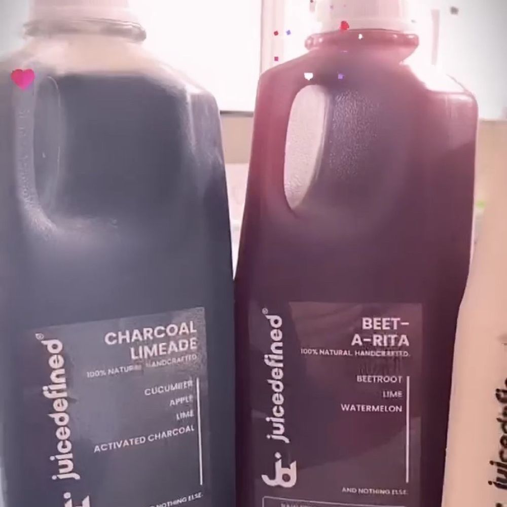 JuiceDefined - two bottles of juice on a counter - Juice Bars & Smoothies Near Me - Opa Locka, Florida
