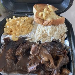 Pot roast w/gravy, white rice, garlic bread and macaroni and cheese.