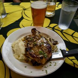 Pork chop and mashed potatoes and grilled onion gravy.