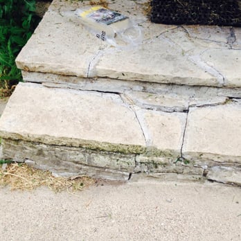 Ranger Property Services - a cat sitting on a stone step - Snow Removal Near Me - Blaine, Minnesota