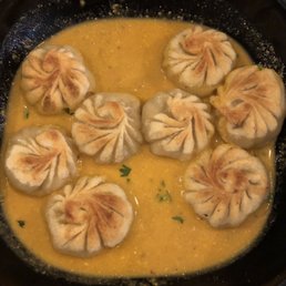 Pan fried dumplings in sesame sauce.