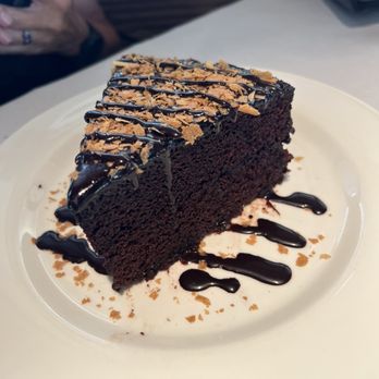 Doc B's Restaurant + Bar - Rob's Double Decker Chocolate Cake topped with chocolate sauce and crispy wafer - New American Near Me - Fort Worth, Texas