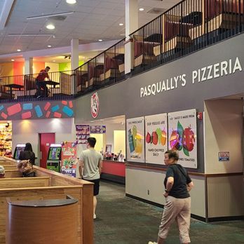 Chuck E. Cheese - The image shows the inside of a Chuck E. Cheese location with seating, arcade machines, and a pizzeria counter named Pasqually's Pizzeria. - Pizza Near Me - San Jose, California