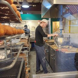 a man working in a commercial kitchen a man working in a commercial kitchen