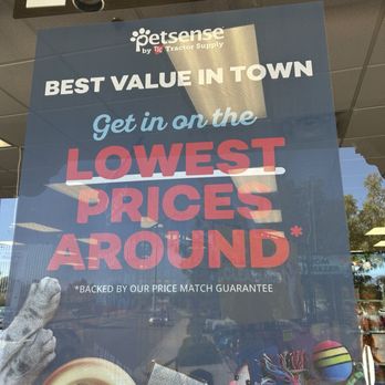 Petsense - A window sign for Petsense by TSC Tractor Supply promotes low prices and price matching, with images of pet toys, a bowl of pet food, and a stuffed animal. - Pet Groomers Near Me - Rio Rancho, New Mexico