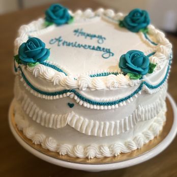 Olde Tyme Pastries - a white cake with blue roses - Bakeries Near Me - Turlock, California Olde Tyme Pastries - a white cake with blue roses - Bakeries Near Me - Turlock, California