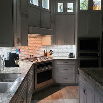 Brett's Kitchen & Bath - a kitchen with white cabinets and a white brick backsplash - Cabinetry Near Me - Tucson, Arizona