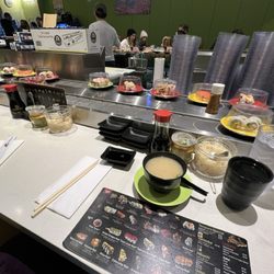 Sushi Hurray - Sitting st the sushi bar and wanting the different items go by on the conveyer belt. Most seats are at the bar. There are also 3 booths.