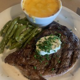 Rare Ribeye with truffle butter, baked macaroni and cheese, and fresh green beans. Rare Ribeye with truffle butter, baked macaroni and cheese, and fresh green beans.