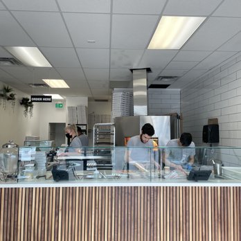 Wild Flour Pizza - a woman behind the counter - Pizza Near Me - Burnaby, British Columbia