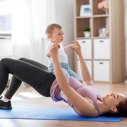 Saunders Therapy Centers - New mother performing stabilization exercises with her baby.