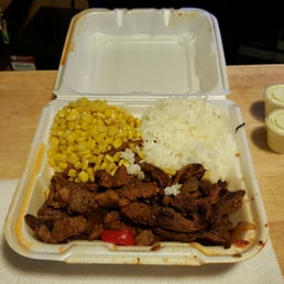 a takeout container with rice and corn a takeout container with rice and corn