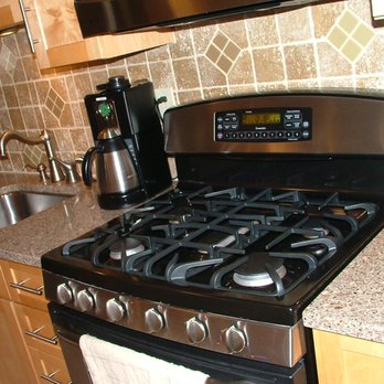 Cosmo's Contracting - a kitchen with stainless steel appliances - General Contractors Near Me Cosmo's Contracting - a kitchen with stainless steel appliances - General Contractors Near Me