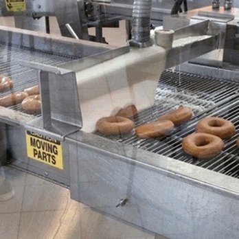 Krispy Kreme - Beautiful glazed donuts on the conveyor belt - Donuts Near Me - Erie, Pennsylvania