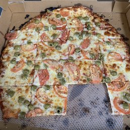Large pizza with green olives, garlic, and sliced tomatoes. Large pizza with green olives, garlic, and sliced tomatoes.