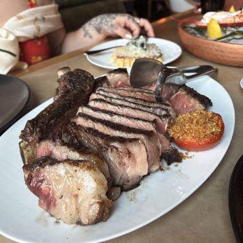 Bourbon Steak - Steak and Mac and cheese in the background - Steakhouses Near Me - New York, New York Bourbon Steak - Steak and Mac and cheese in the background - Steakhouses Near Me - New York, New York