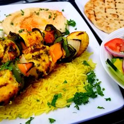 Pita Island - Chicken Kebab Platter with charred peppers and onions includes a side Greek Salad, hummus, tzatziki and a Greek pita