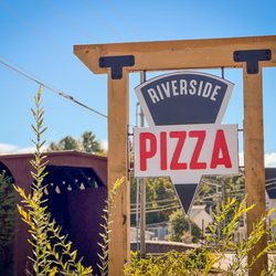 Riverside Pizza - Our street sign with historic covered bridge in the background