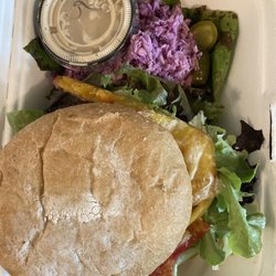 The Vegan Farmer - Baharat burger (indian-spiced chickpea+oat burger) with fresh tomatoes and included side of tahini and cole slaw. $11 and so worth it!