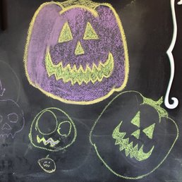 a chalk drawing of a pumpkin and a jack o lantern