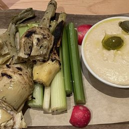 Humus appetizer with warm grilled artichokes, celery, radishes, green olives and what looked like pita bread Humus appetizer with warm grilled artichokes, celery, radishes, green olives and what looked like pita bread