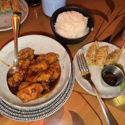 Orange chicken and steamed rice with pot stickers Orange chicken and steamed rice with pot stickers