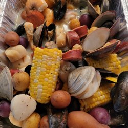 Corn, potato, sausage, and shrimp with mussels and clams in a lemon garlic herb seasoning cooked in Sauvignon Blanc!