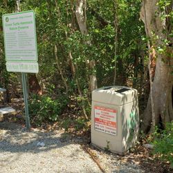 Their trash and recycling receptacle along with the rules of the place.