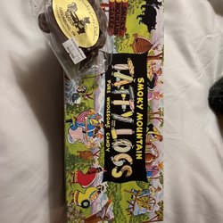 Ole Smoky Candy Kitchen - Taffy logs in an adorable box and a chocolate covered pecan praline.