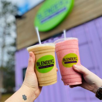 Blenderz - a hand holding two cups of blenderz - Juice Bars & Smoothies Near Me - Mio, Michigan