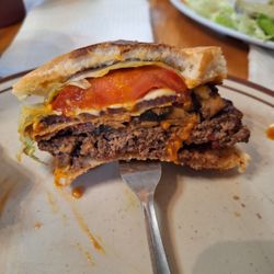 Atkins International Cafe & Deli - Beautiful burger with cheese, bacon, and mushrooms. Absolutely delicious. Even with all that, you can still taste the beef.