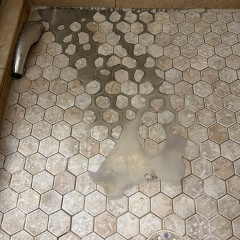 ProSource of Daytona Beach - Thinset from the living room went through the wall into shower through a broken pan. - Flooring Near Me - Daytona Beach, Florida ProSource of Daytona Beach - Thinset from the living room went through the wall into shower through a broken pan. - Flooring Near Me - Daytona Beach, Florida