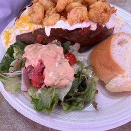 Special- baked potato with fried shrimp, cheese sauce, sour cream, a side salad and bread