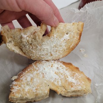 Suburban Eats - a hand holding a half eaten pastry - Delis Near Me - Melville, New York