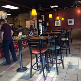 a man standing at a counter in a restaurant