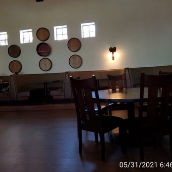 Swiftwater Cellars - a dining room with wine barrels on the wall - New American Near Me - Cle Elum, Washington