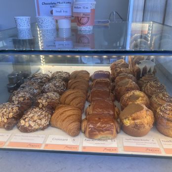 Parfait Paris - Almond Croissant (Croissant Aux Amandes) on the very far left, New York vanilla croissant roll very far back right. - Bakeries Near Me - Coronado, California Parfait Paris - Almond Croissant (Croissant Aux Amandes) on the very far left, New York vanilla croissant roll very far back right. - Bakeries Near Me - Coronado, California