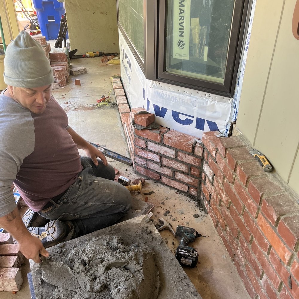 Jones Masonry - a man working on a brick wall - General Contractors Near Me Jones Masonry - a man working on a brick wall - General Contractors Near Me
