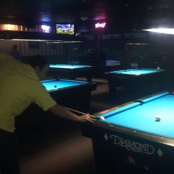 Bumpers Billiards - a man playing pool - Pool Halls Near Me - Huntsville, Alabama