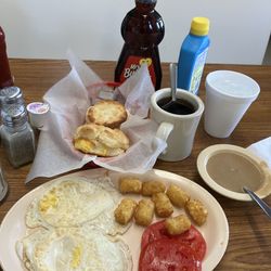 D & A Cafe - Two egg breakfast with tater tots, coffee and tomato. Comes with two biscuits and gravy. I added cheese to the biscuit.