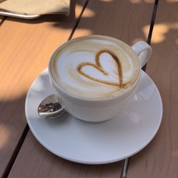 Arhoma - a cup of cappuccino on a table - Bakeries Near Me - Montreal, Quebec