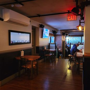Long Acre Tavern - a man sitting at a table - Sports Bars Near Me - New York, New York Long Acre Tavern - a man sitting at a table - Sports Bars Near Me - New York, New York