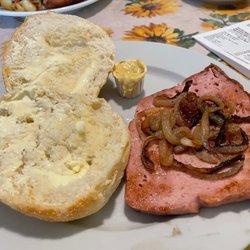 Angelika's German Imports - Fried Fleischkäse with grilled onions and a buttered brötchen. You can add a fried egg to make it a breakfast sandwich.