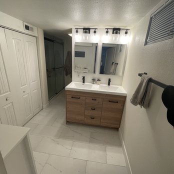 Take Pride Construction - The carpet is GONE! Fitting 2 mirrors, 2 lights and a dual sink vanity on a 48 inch wall was quite the project but its perfect! - General Contractors Near Me