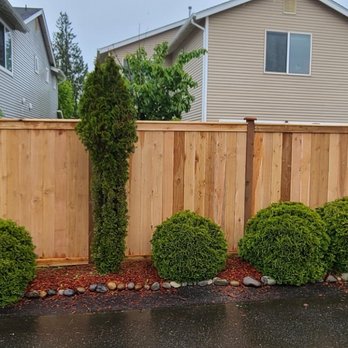 Martinez Brothers Landscaping - a wooden fence with shrubs - Landscaping Near Me