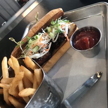 Finch - My husband loved it.  "pork belly bahn mi" maple hoisin glazed crispy pork belly, carrots, papaya and cilantro on a toasted french roll - American Near Me - Wildomar, California